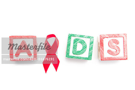 Wood blocks spelling aids using red ribbon on white background