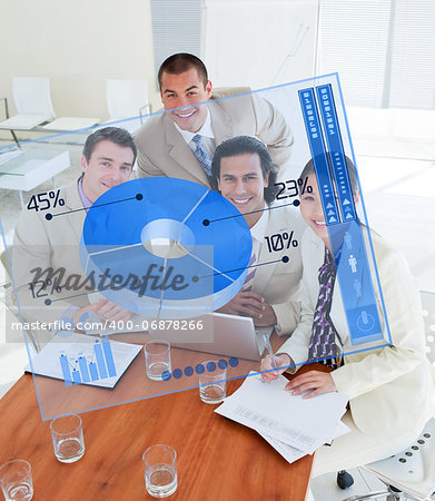 Overview of happy colleagues looking at blue chart interface in a meeting