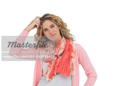 Attractive woman posing and smiling while scratching her head on white background