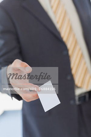 Businessman giving a white blank business card in office