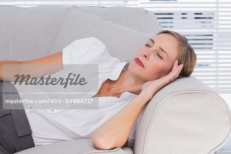 Businesswoman sleeping on couch in the office