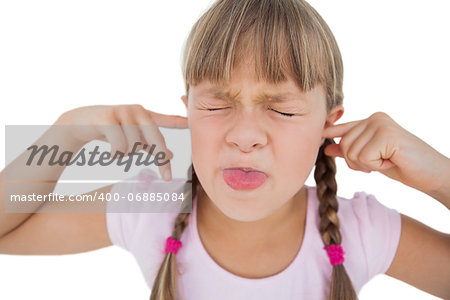 Little girl clogging her ears on white background