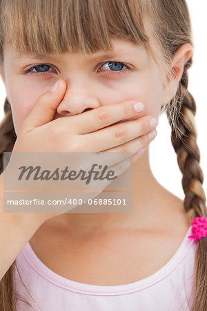 Portrait of a little blond girl with her hand on her mouth on white background
