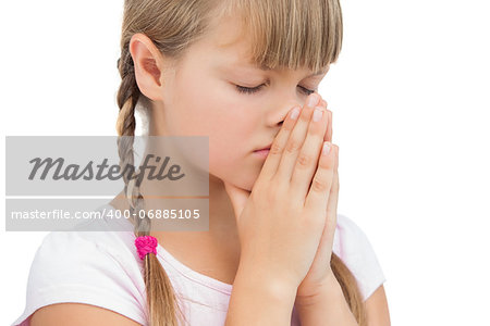 Young girl praying on white background