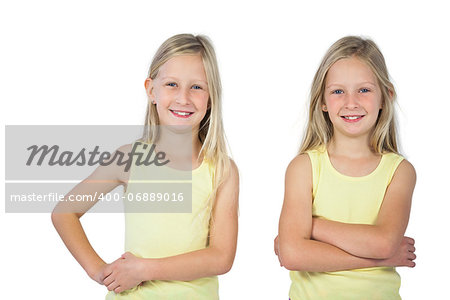 Smiling girls with arms crossed on a white background