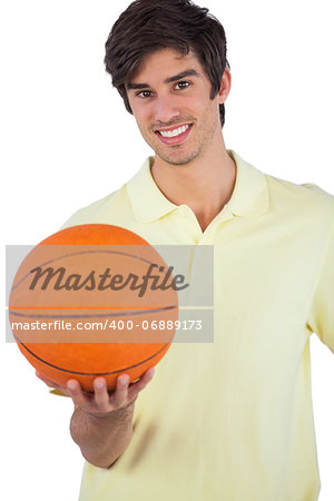 Portrait of a smiling man holding basket ball on a white background