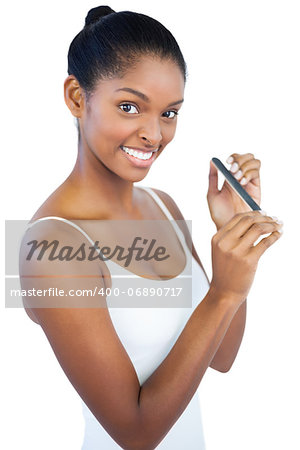 Woman using nail file on white background