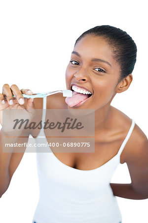 Funny woman brushing her tongue with toothbrush on white background