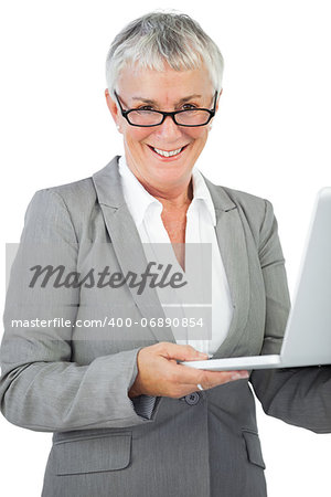 Smiling businesswoman with glasses holding her laptop on white background