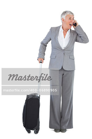 Businesswoman calling and has luggage on white background