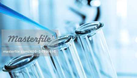 pipette and test tube on blue