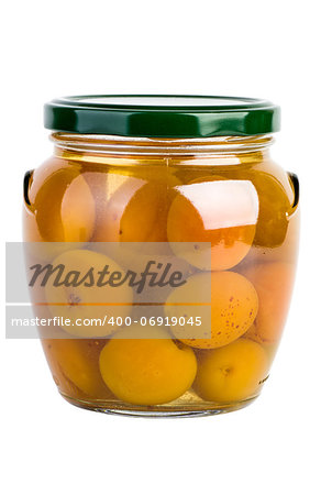 Glass jar with preserved apricots on the white background