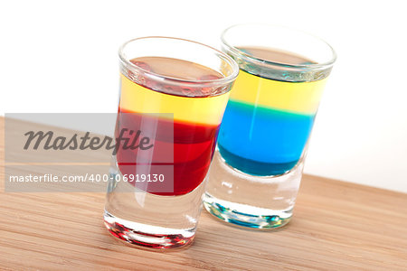 Shot cocktail collection: Red and Blue Tequila alcohol cocktail isolated on white background. Ingredients: 1 oz Grenadine (Blue Curacao), 1 oz Gold Tequila