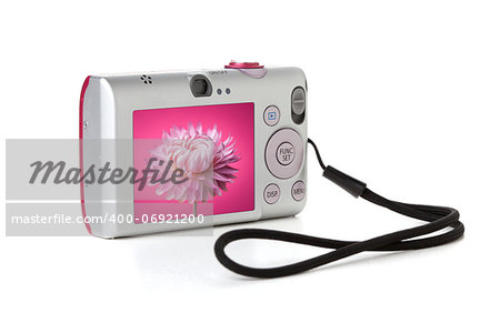 Compact digital camera with pink flower on display. Isolated on white background