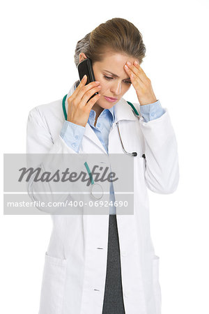 Concerned doctor woman talking mobile phone