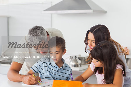 Family drawing together in kitchen at home