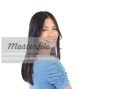 Smiling asian woman looking over her shoulder on white background