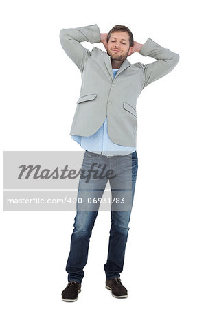 Suave man in a blazer with hands behind head on white background