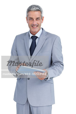 Happy businessman with tablet pc against white background