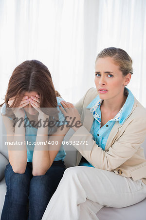 Crying woman with her therapist on couch at office