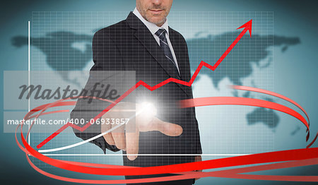 Businessman touching growth graph on futuristic interface with red arrow in world map background