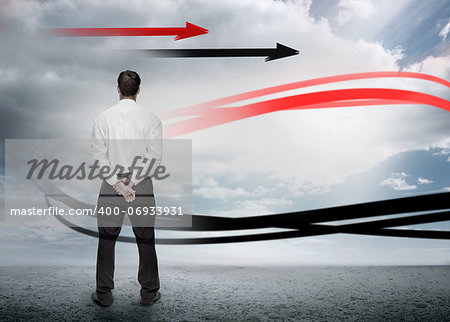 Businessman looking at red and black arrows in cloudy landscape