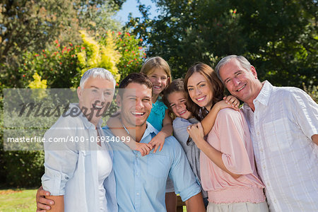 Smiling family and grandparents in the countryside looking at camera