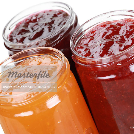 Marmalade made from strawberries, cherries and apricots in jars, isolated on white
