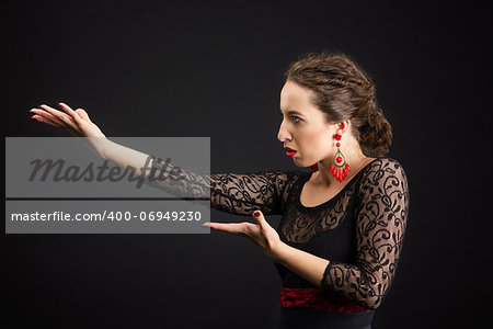 Flamenco dancer in black dress with red earrings