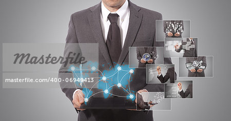 business man holding a tablet, grey background. world map from www.lib.utexas.edu