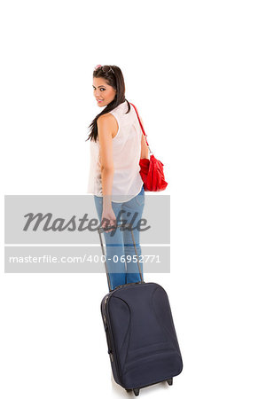 Beautiful traveling businesswoman carrying black travel suitcase and looking back over her shoulder on white background.