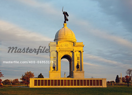 The Pennsylvania Monument in Gettysburg National Military Park illuminated with early morning sunlight.