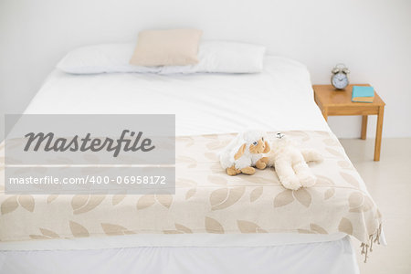 Brightly lit bedroom decorated in white and beige