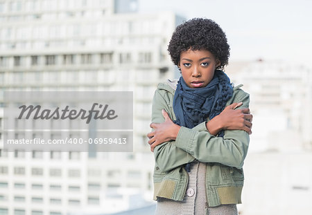 Shivering gorgeous woman posing outdoors on a sunny day