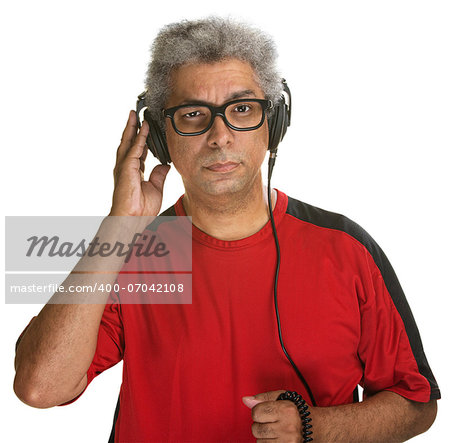 Suspicious Hispanic male holding earphones on head