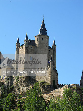 Castle in Segovia on a mount against the blue sky