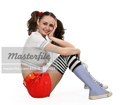 girl in striped socks and orange mini skirt sitting on a white floor