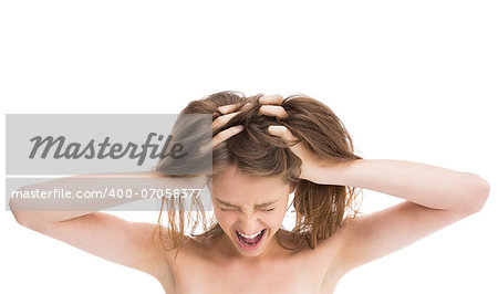 Bare girl with hands on head screaming against white background