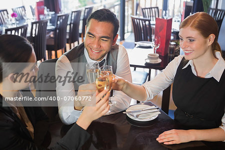 Business team toasting with champagne in a restaurant
