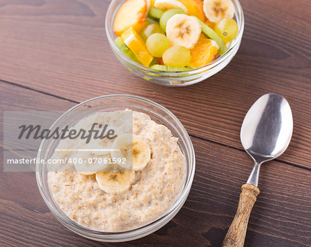 Oat porridge and fruits on a wooden table