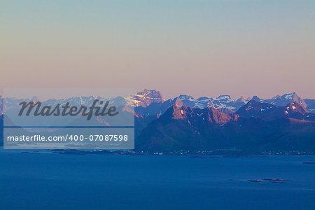 Mountain peaks on Lofoten islands in Norway lit by midnight sun in early summerz