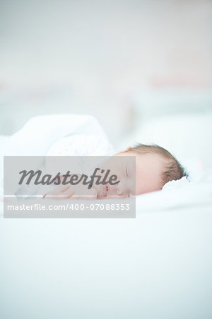 Cute Newborn Baby Laying on White Bed