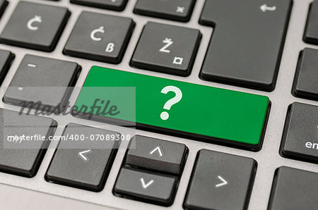 Green question mark key on computer keyboard.