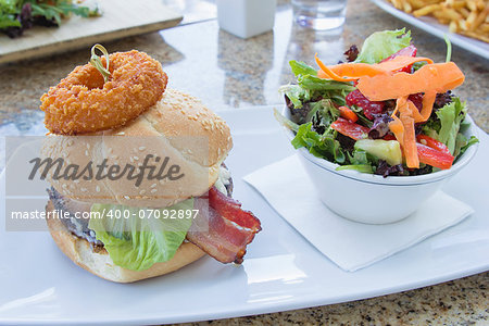Hamburger with Onion Ring Ham Beef Patty Lettuce and Bowl of Organic Vegetable Salad