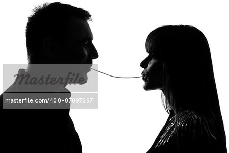 one caucasian couple man and woman eating the same spaghetti in studio silhouette isolated on white background