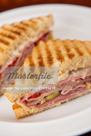 An Italian deli classic ham salami and provolone sandwich on sourdough bread.