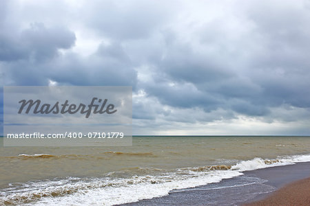 Storm clouds over the sea surface. Coastal sea water after the storm contaminated dredged from the seabed sand