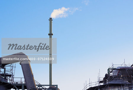 Smokestack of factory at a clear summer day.