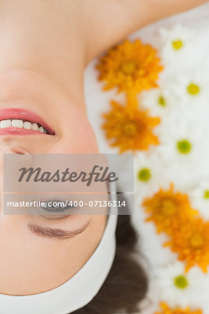 Overhead portrait of a beautiful young woman with flowers in beauty salon