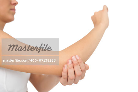 Woman touching her sore elbow on white background